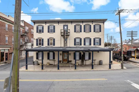 a front view of a residential apartment building with a yard