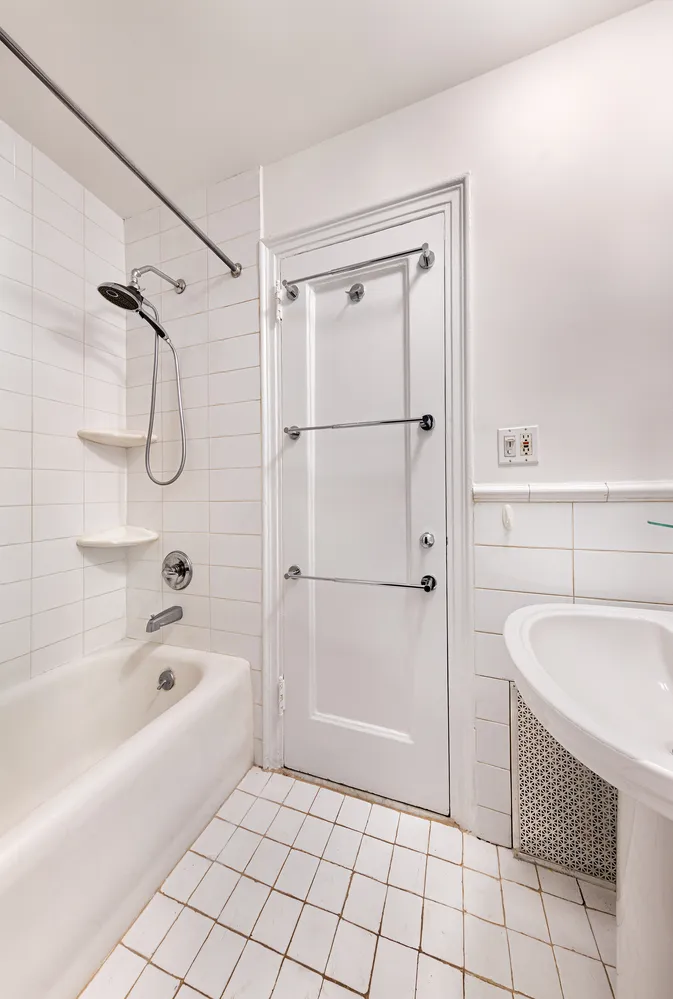 a bathroom with a granite countertop sink a mirror and a bathtub