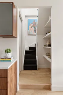 a view of hallway with stairs and wooden floor