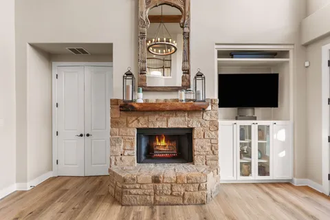 a bathroom with a granite countertop sink a toilet a mirror and shower