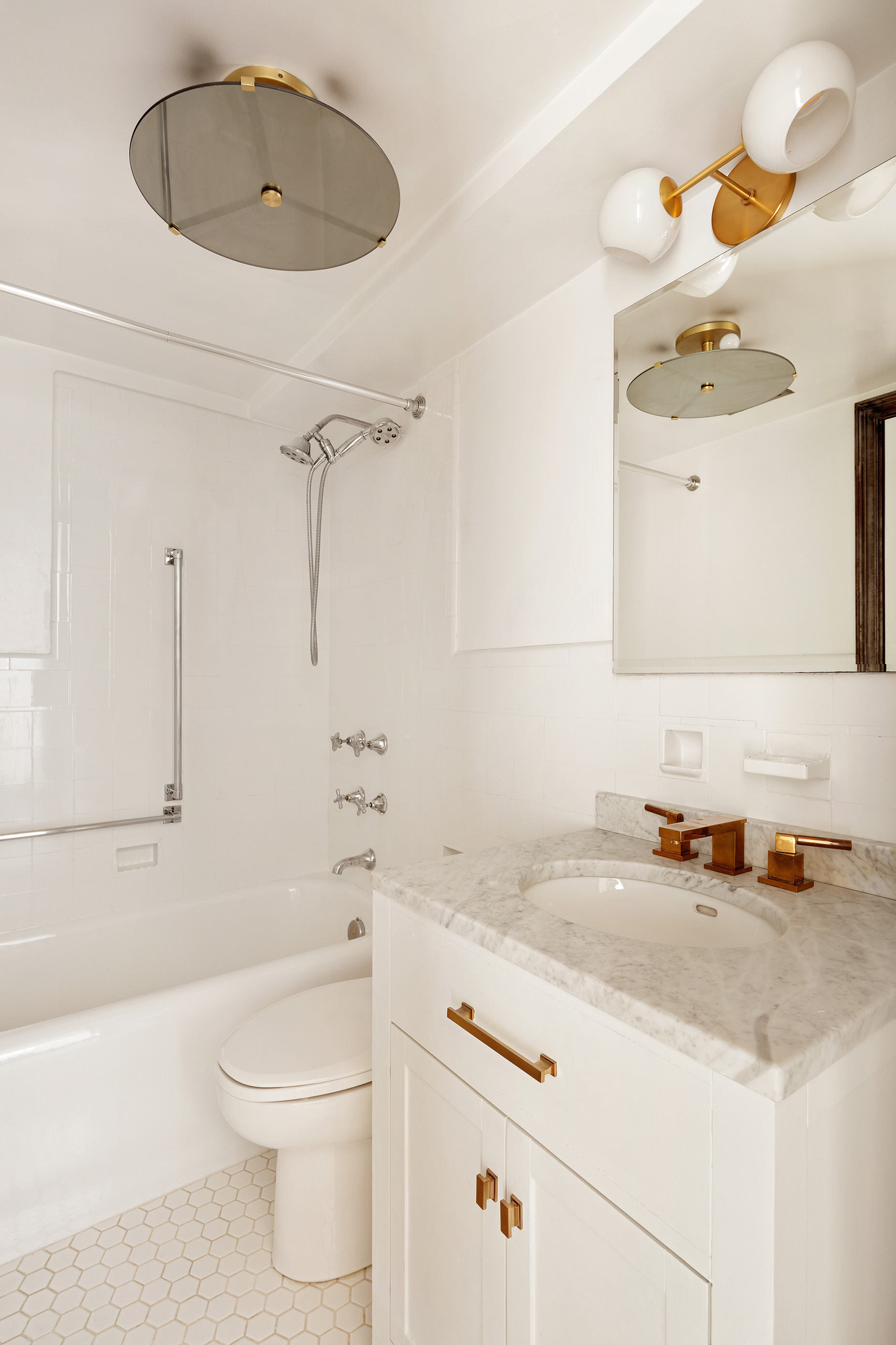 200 East 16th Street, Unit 16L Manhattan, NY 10003 - Photo 6 of 12 a bathroom with a sink a toilet and shower
