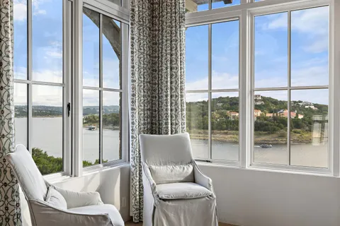a room with lots of windows and tables