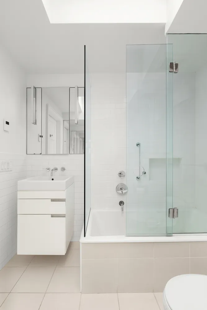 a bathroom with a bathtub sink vanity and toilet