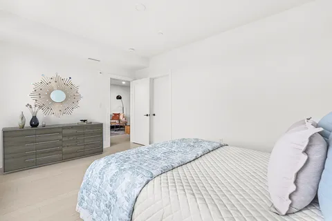 a bedroom with a bed and a dresser