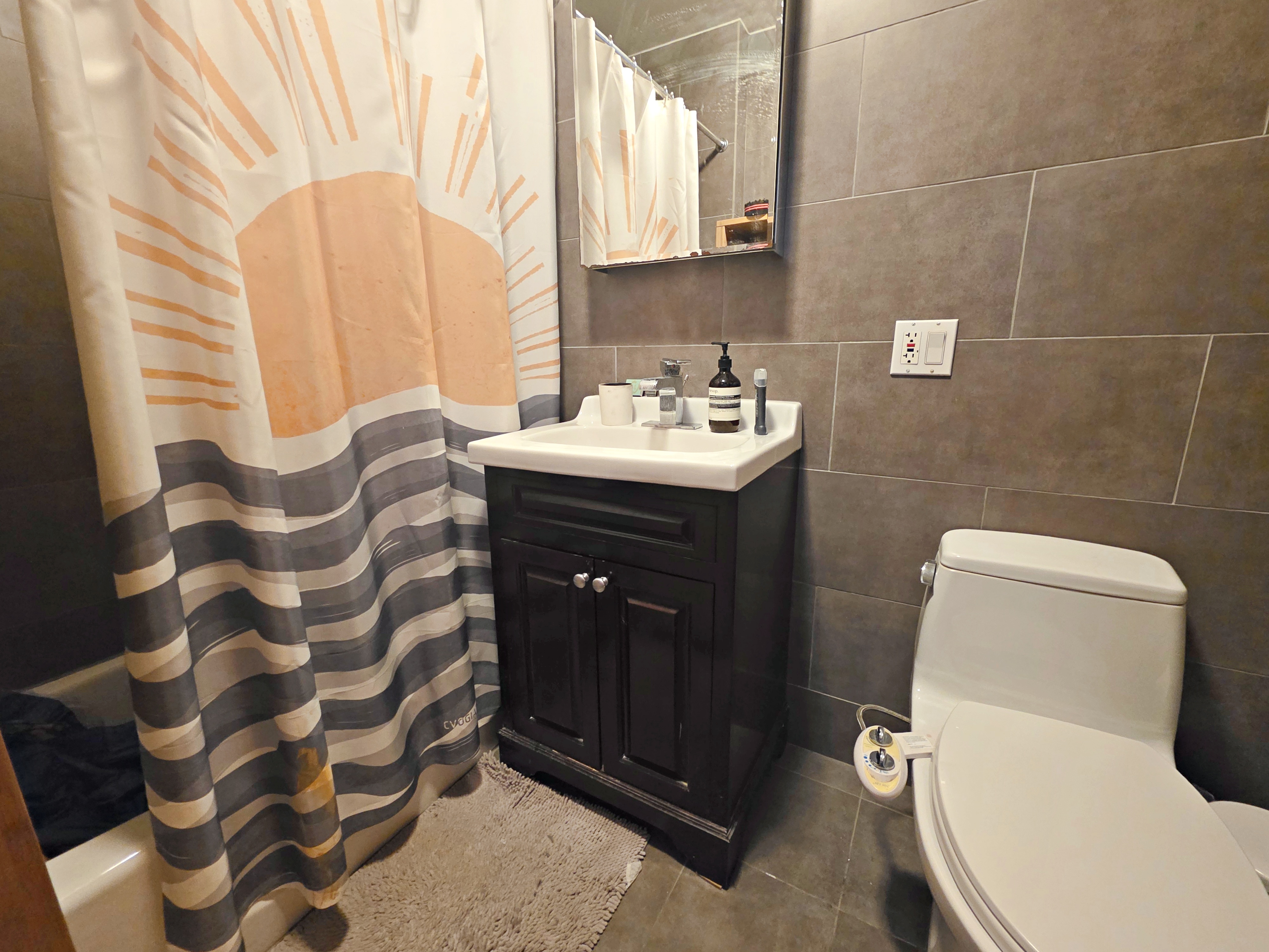 713 Metropolitan Avenue, Unit 4R Brooklyn, NY 11211 - Photo 7 of 11 a bathroom with a sink toilet and shower