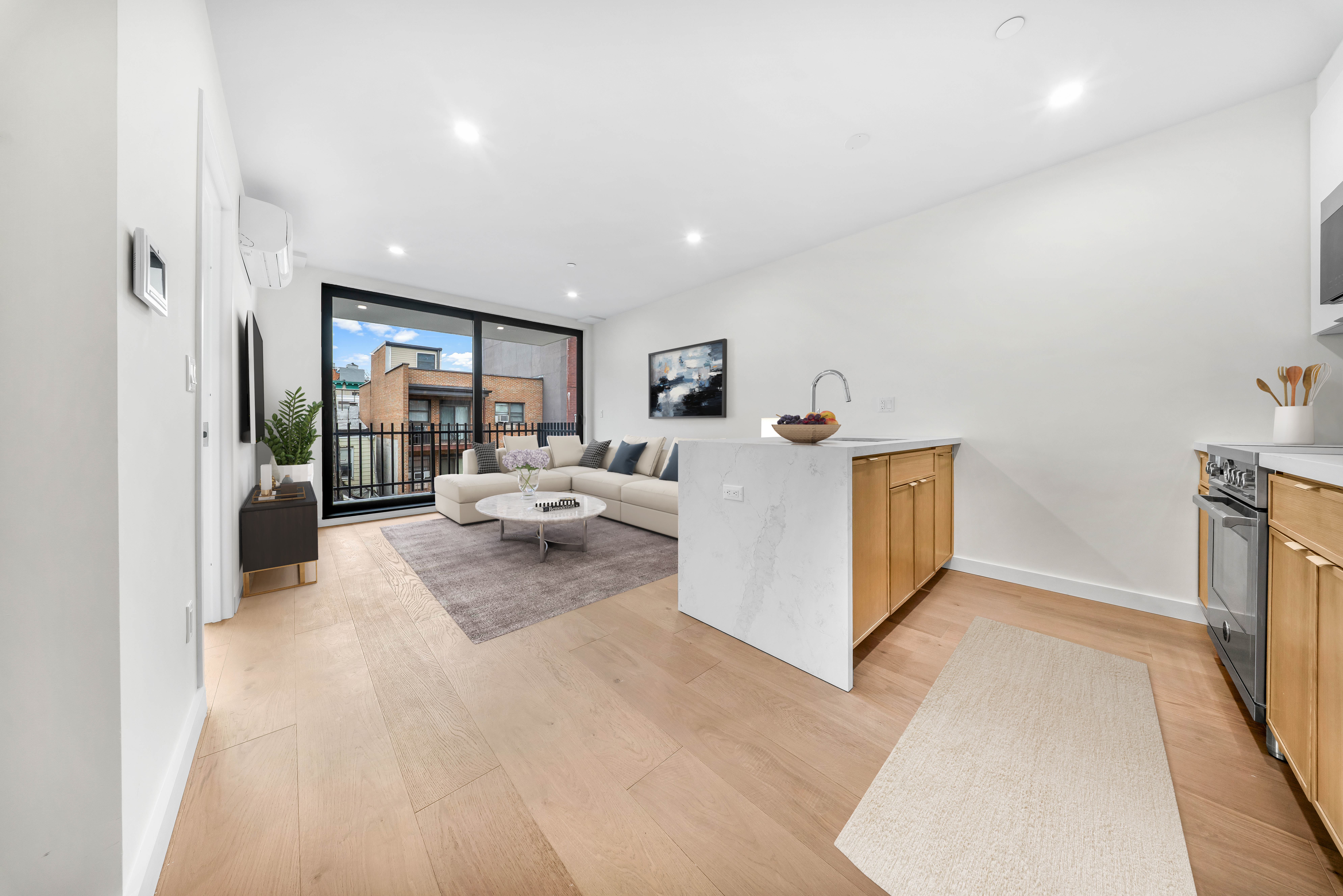 30-24 32nd Street, Unit 3A Queens, NY 11102 - Photo 16 of 18 a living room with furniture and a large window