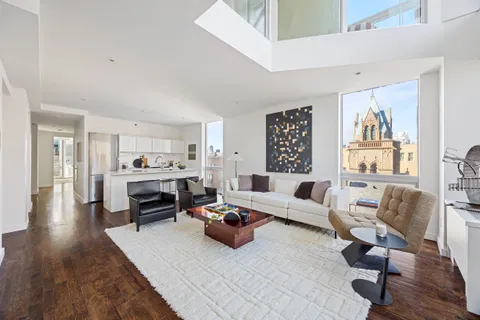 a living room with furniture or kitchen view and a wooden floor