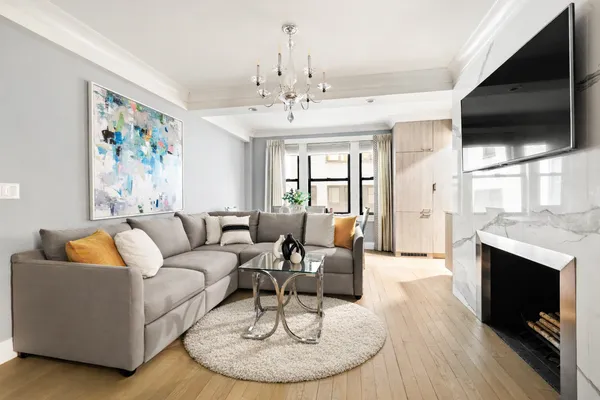 a living room with fireplace furniture and a flat screen tv