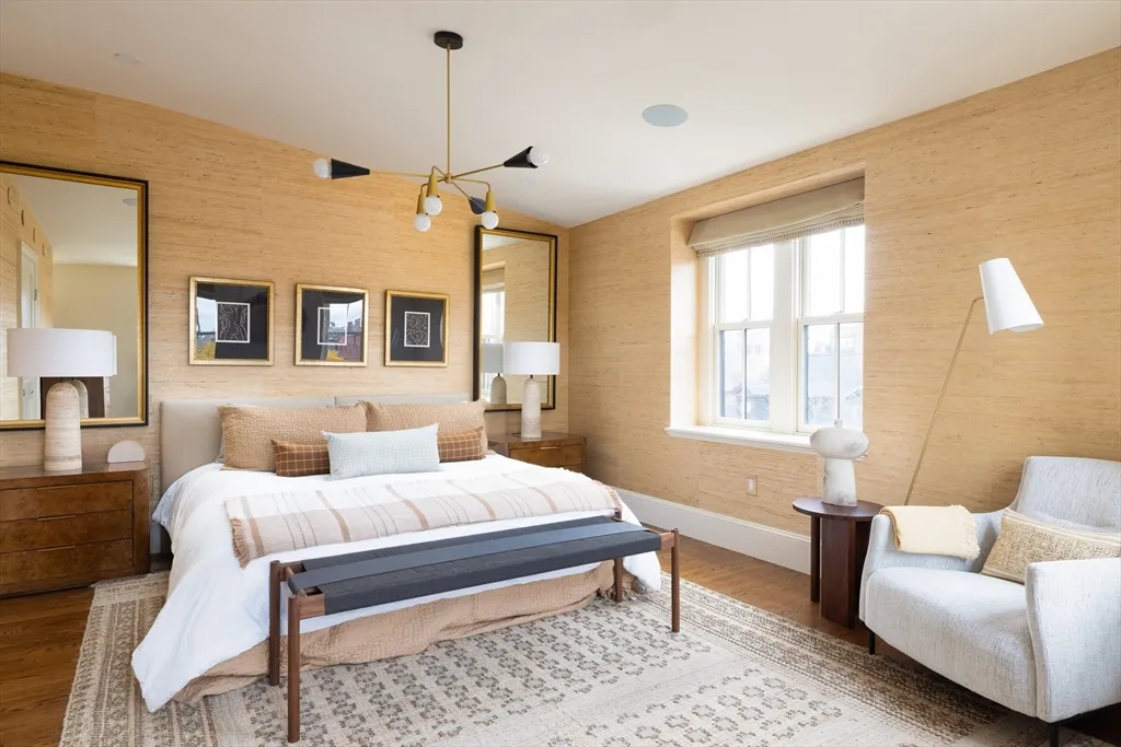 a bedroom with a bed a couch and dresser