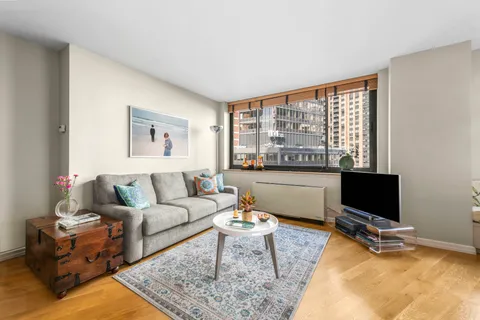 a living room with furniture window and a flat screen tv