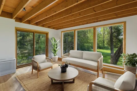 a living room with furniture and a floor to ceiling window