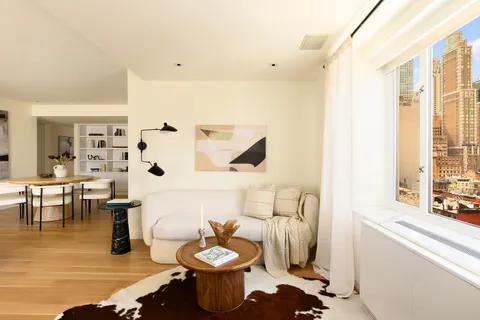 a dining room with furniture and wooden floor