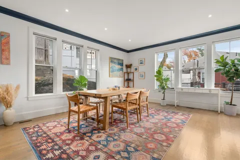 a dining room with furniture and wooden floor