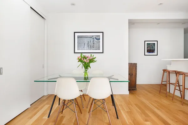 a view of a dining room with furniture and wooden floor