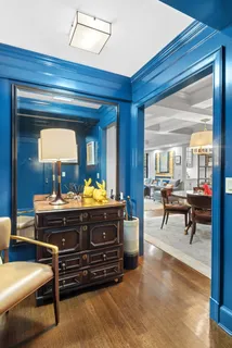 a room with a table chairs and a dresser