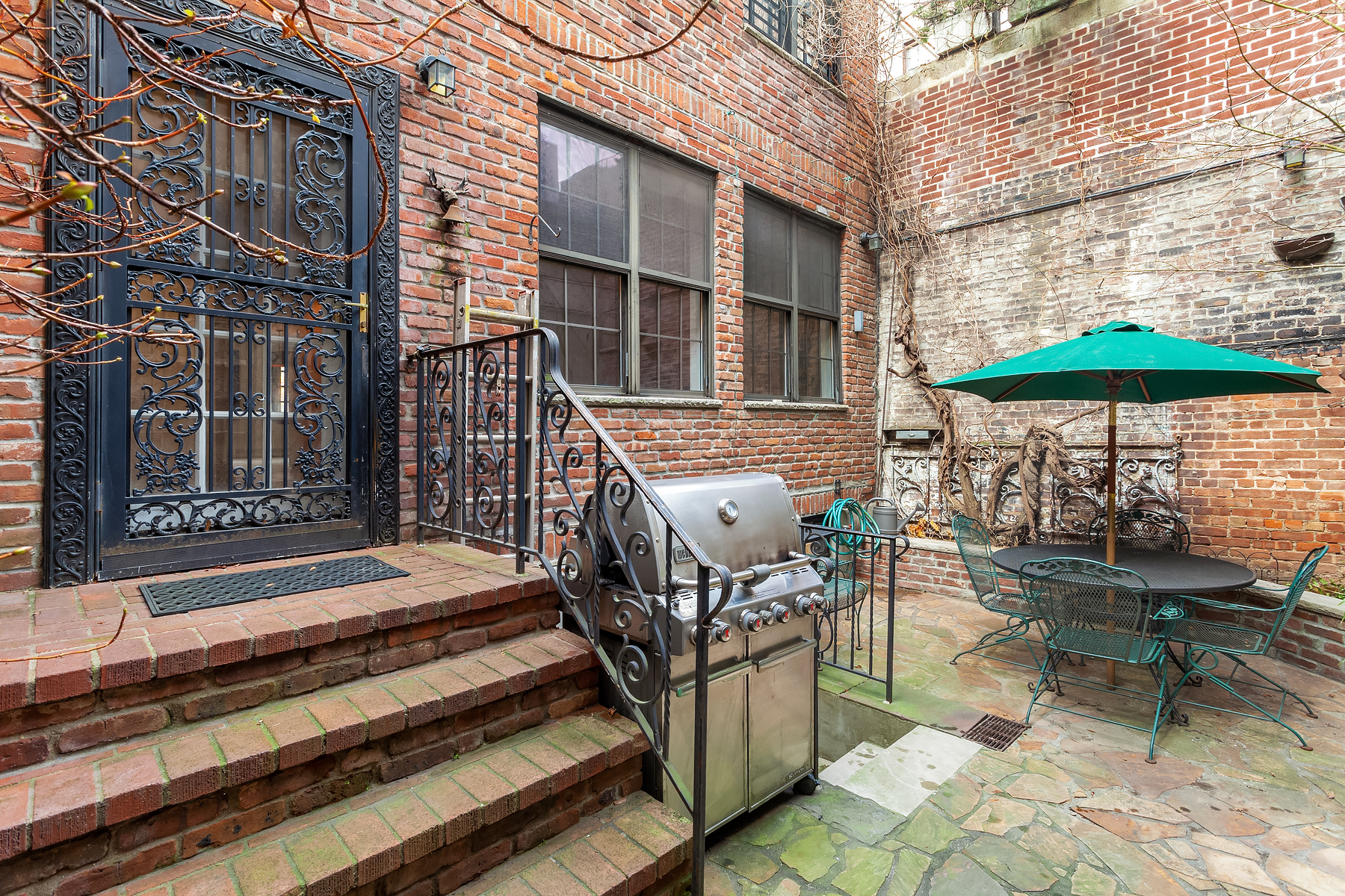 57 Sullivan Street, Unit DUPLEX Manhattan, NY 10012 - Photo 6 of 9 a balcony with hardwood table and chairs