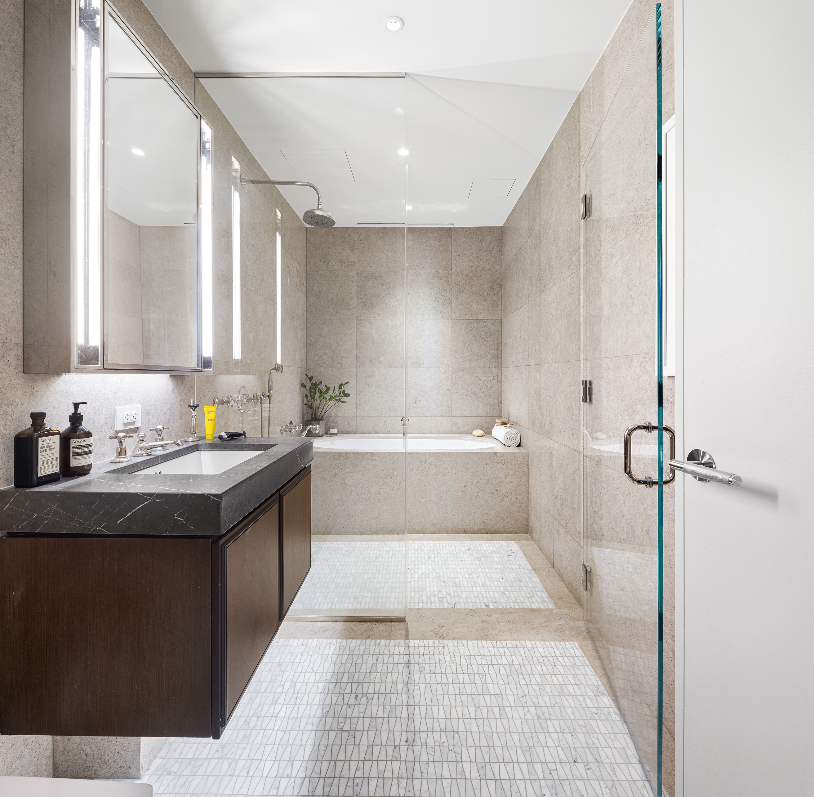 5 Beekman Street, Unit 20B Manhattan, NY 10038 - Photo 10 of 12 a bathroom with a granite countertop sink a mirror and a bathtub