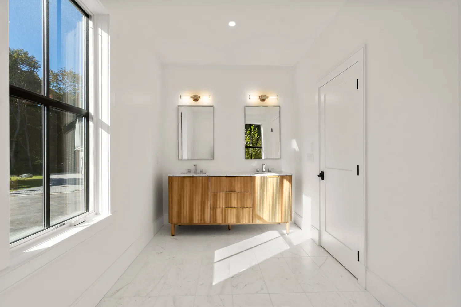 a view of a kitchen with cabinets and a hallway