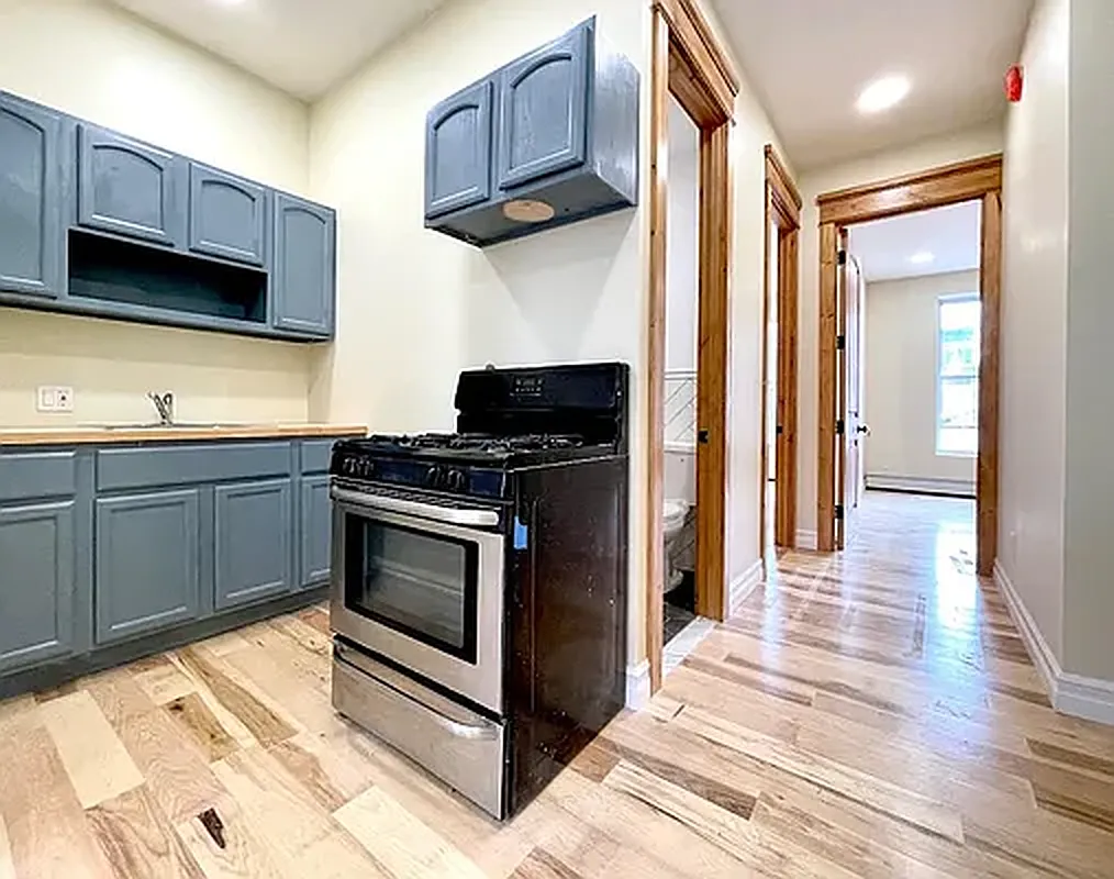 1120 Greene Avenue, Unit 1 Brooklyn, NY 11221 - Photo 1 of 13 a kitchen with stainless steel appliances granite countertop a stove a sink and a microwave