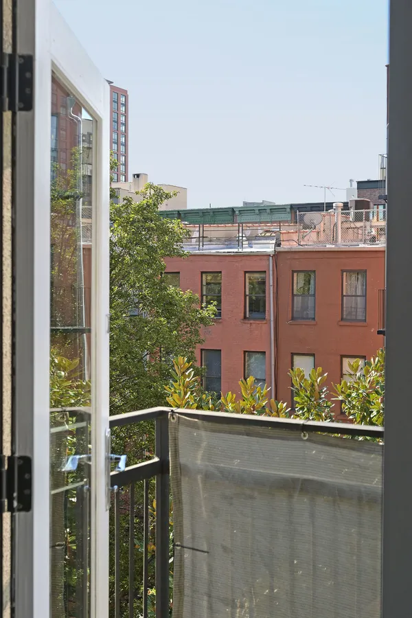 a view of balcony with two tall buildings