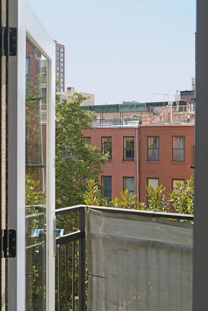 a view of balcony with two tall buildings