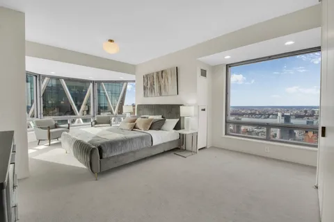 a bedroom with a large bed and a large window