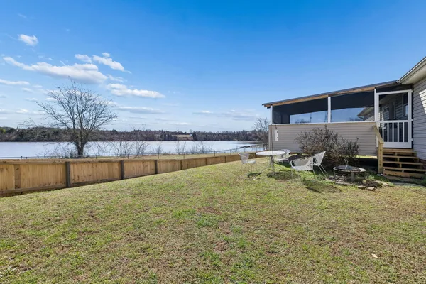 a swimming pool with outdoor seating and yard