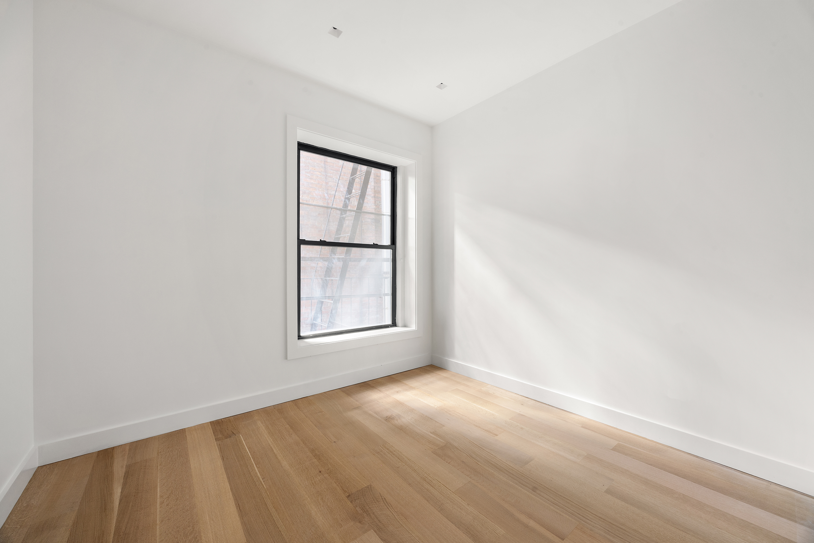 243 West Broadway, Unit 4 Manhattan, NY 10013 - Photo 11 of 14 an empty room with a window