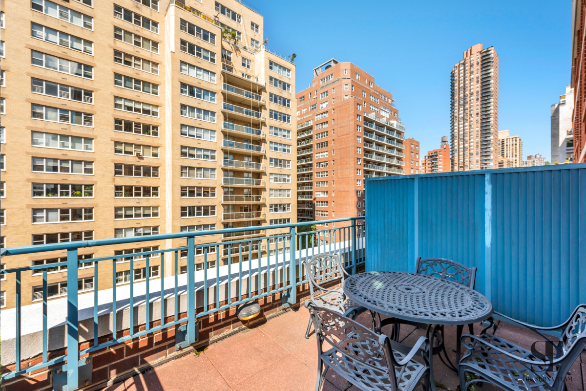 404 East 76th Street, Unit 7C Manhattan, NY 10021 - Photo 1 of 13 a view of a balcony with a table and chairs