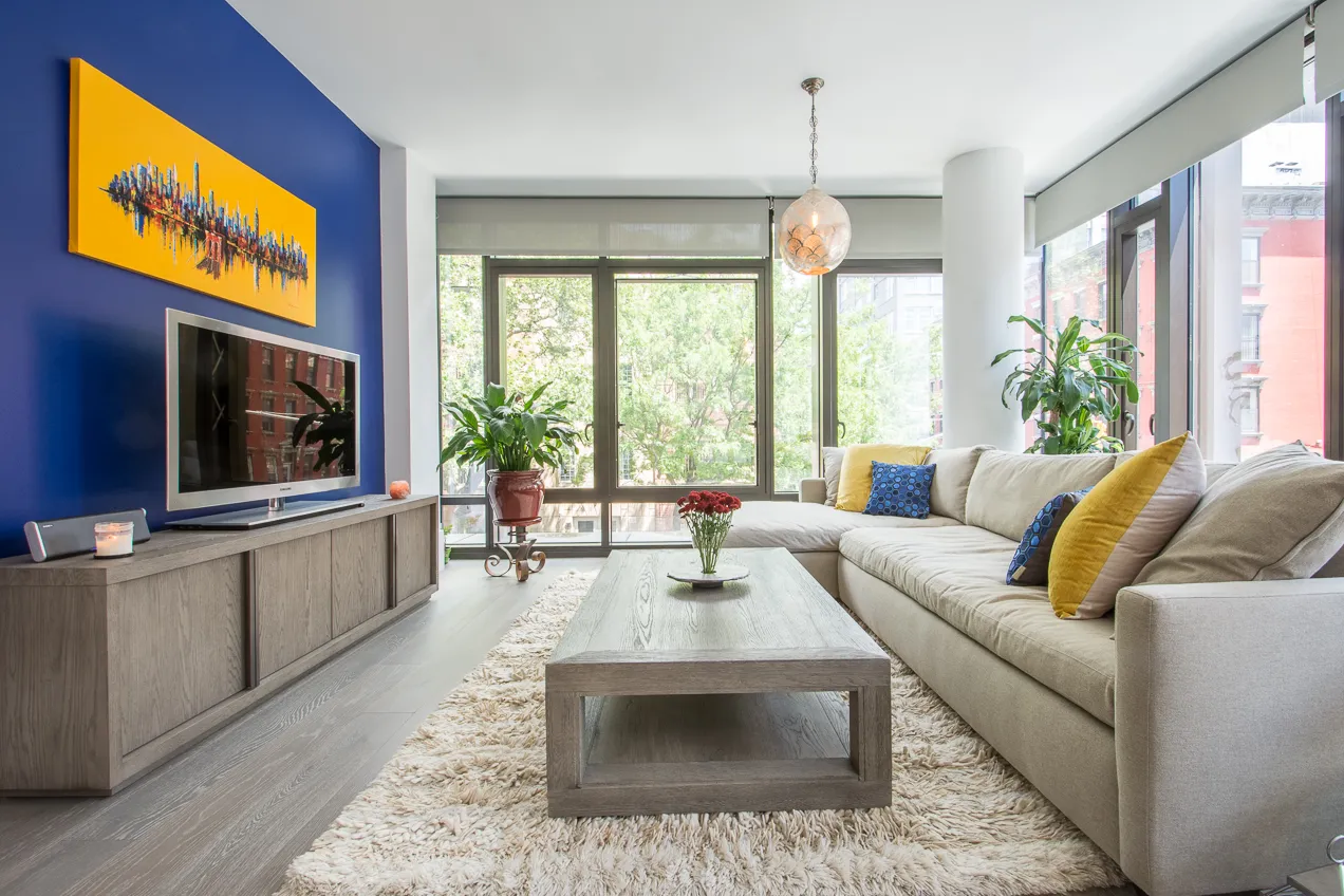 a living room with furniture a flat screen tv and a fireplace