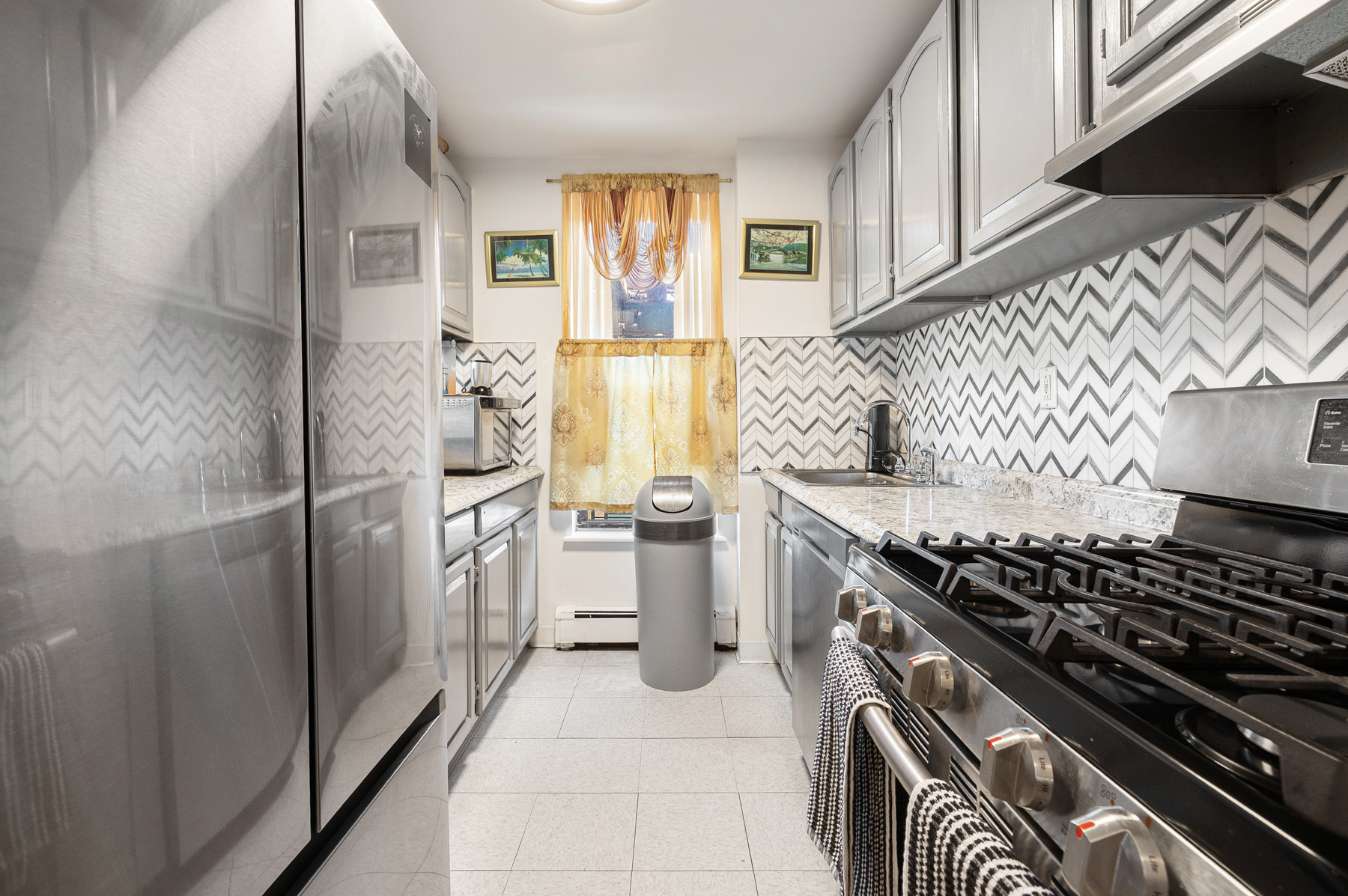 106 Crescent Street Brooklyn, NY 11208 - Photo 5 of 18 a kitchen with a stove and a refrigerator