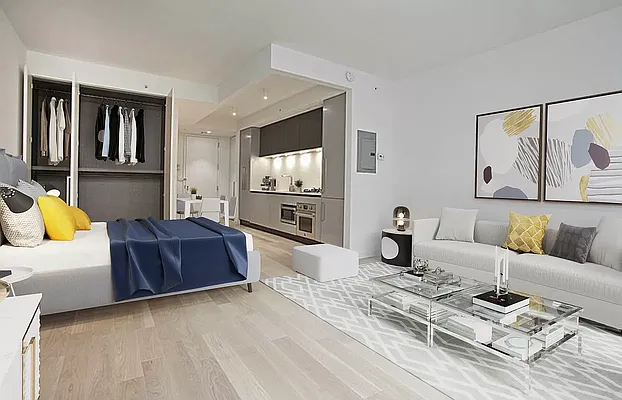 a living room with furniture a flat screen tv and kitchen view