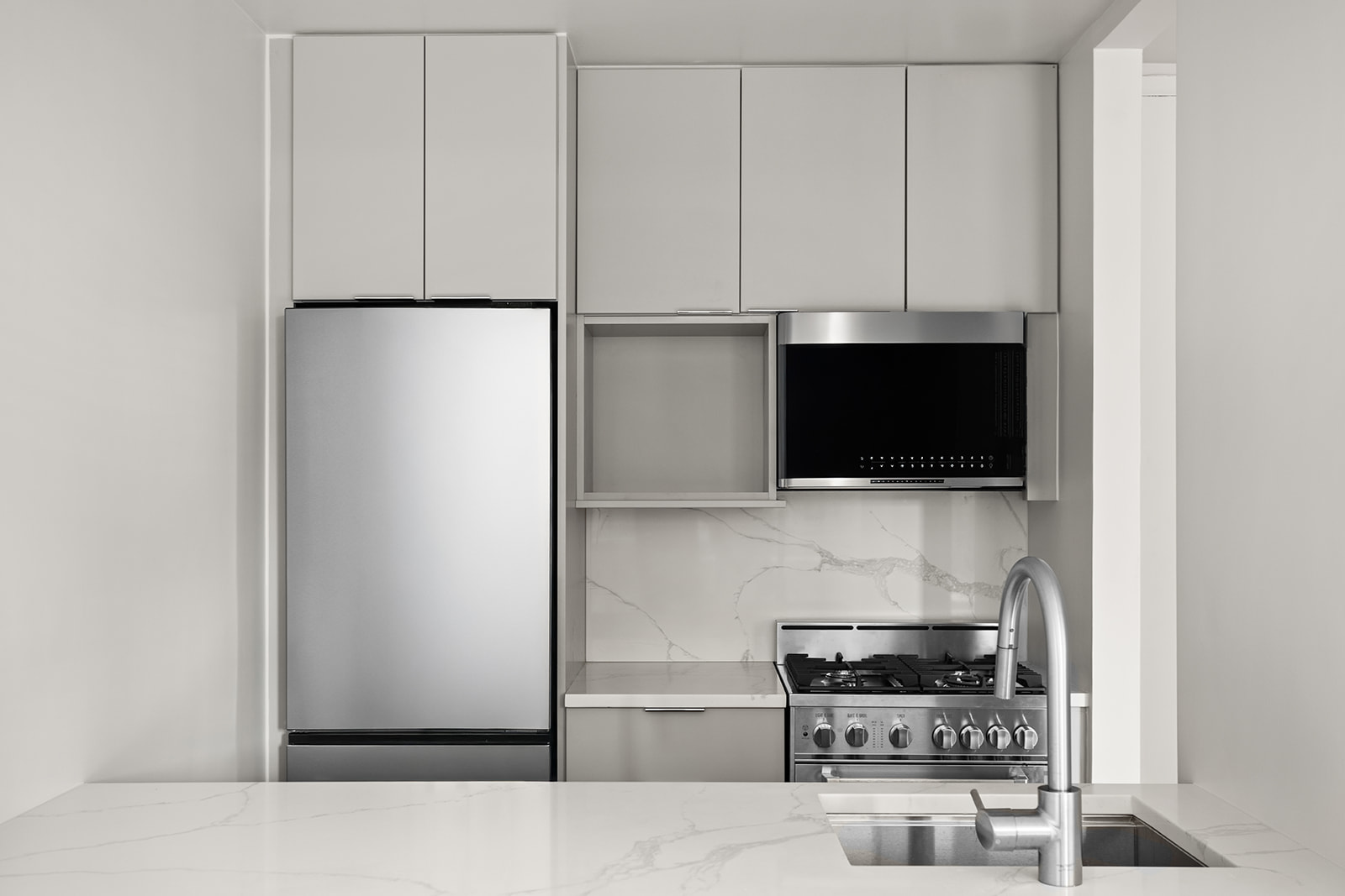 500 West 43rd Street, Unit 3B Manhattan, NY 10036 - Photo 5 of 19 a kitchen with a microwave and a stove