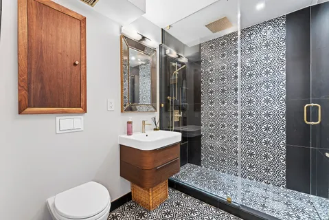 a bathroom with a toilet sink shower and mirror