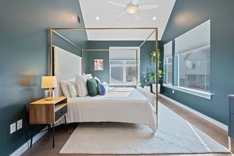 a bedroom with a large bed and a large window