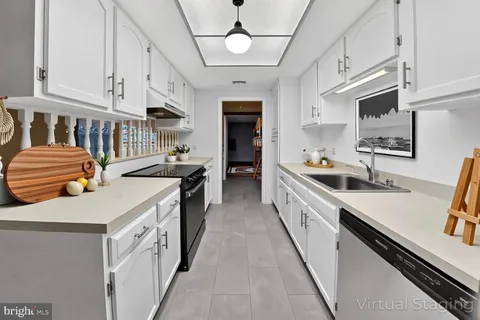 a kitchen with stainless steel appliances sink stove microwave and cabinets