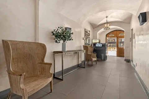 a view of hall way with furniture and chandelier
