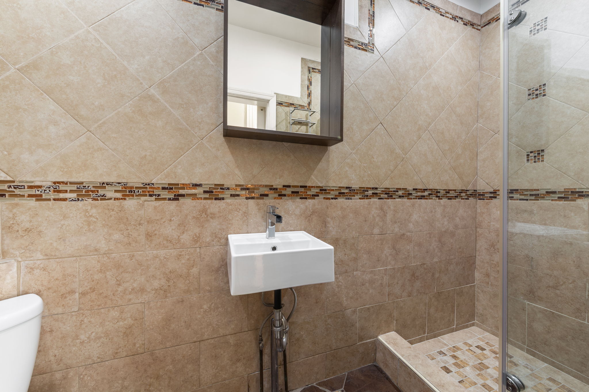 1218 Saint Marks Avenue Brooklyn, NY 11213 - Photo 9 of 42 a bathroom with a sink a mirror and a shower