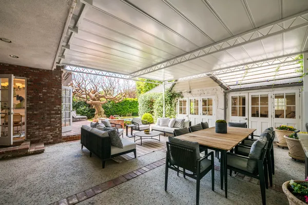 a living room with furniture and a floor to ceiling window