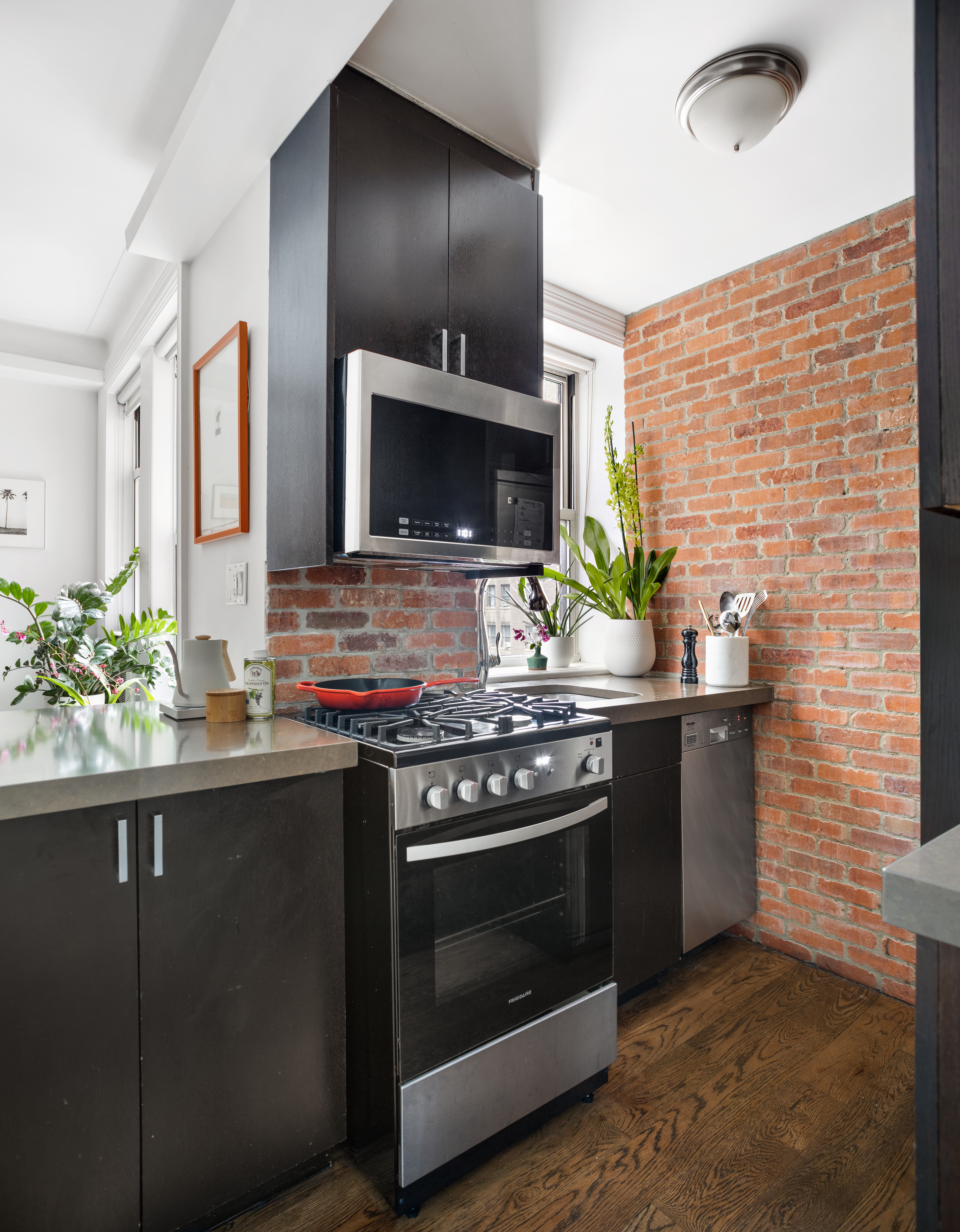 41 West 72nd Street, Unit 6B Manhattan, NY 10023 - Photo 2 of 7 a kitchen with stainless steel appliances a stove and a microwave