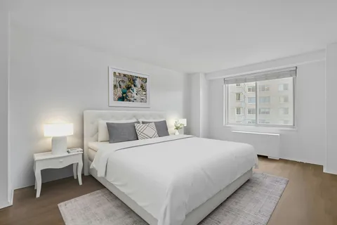 a bedroom with a large bed and a window