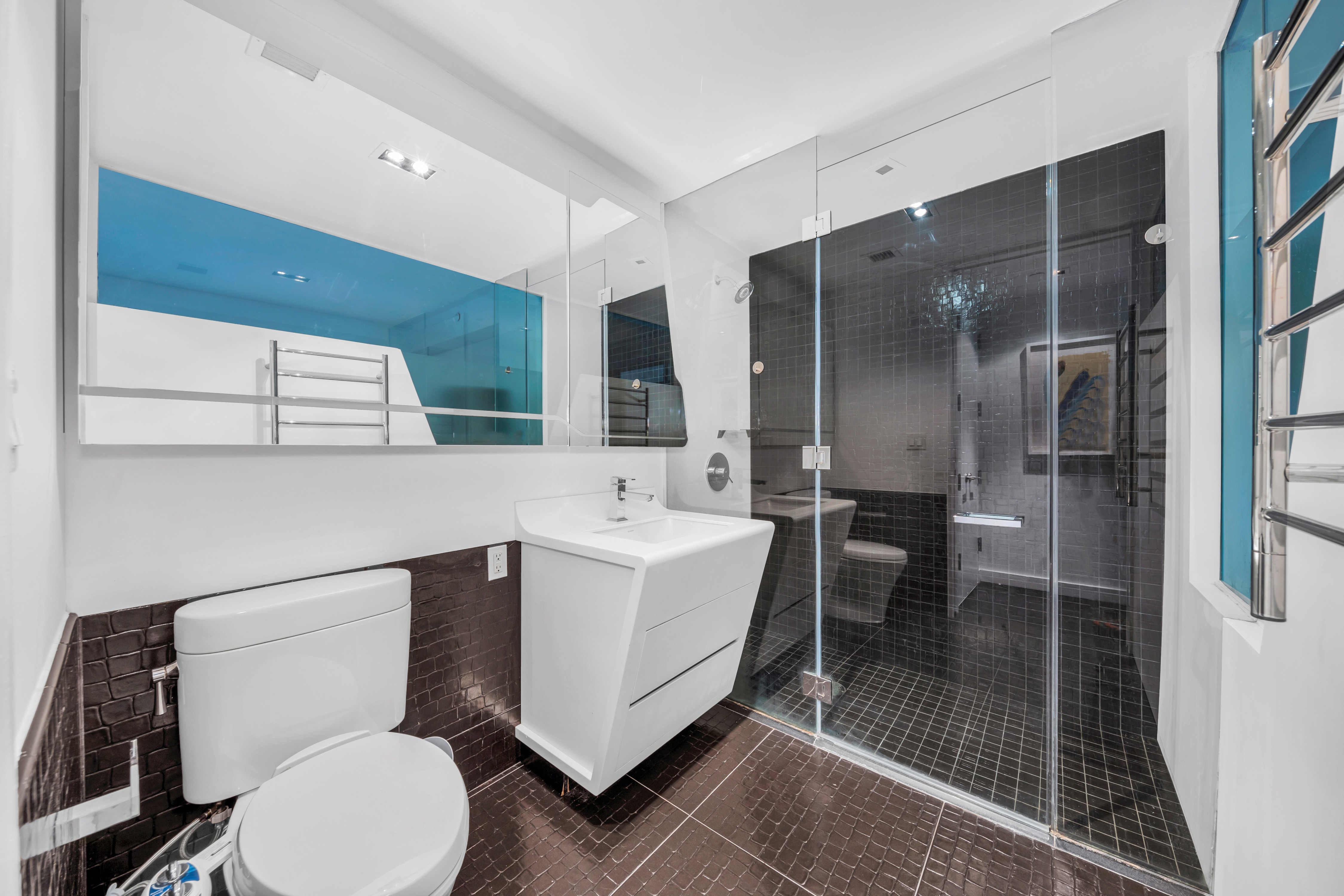 123 Washington Street, Unit 36H Manhattan, NY 10006 - Photo 5 of 8 a bathroom with a sink toilet and shower