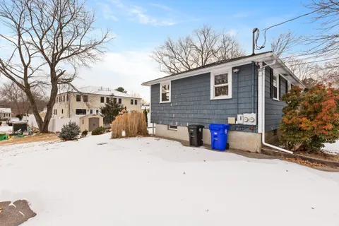 a view of a house with snow on the road