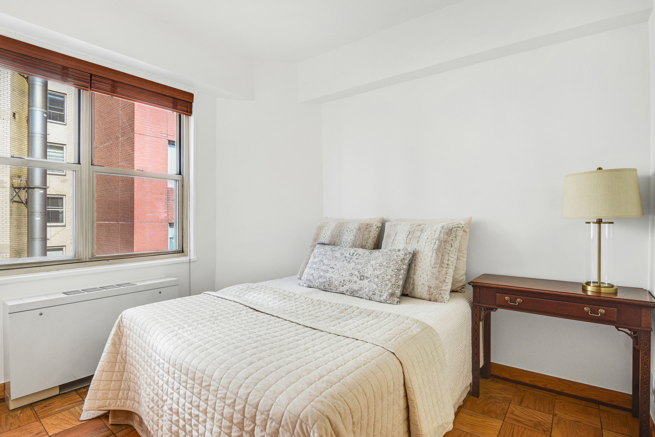 520 East 72nd Street, Unit 10P Manhattan, NY 10021 - Photo 10 of 13 a bedroom with a bed and a lamp