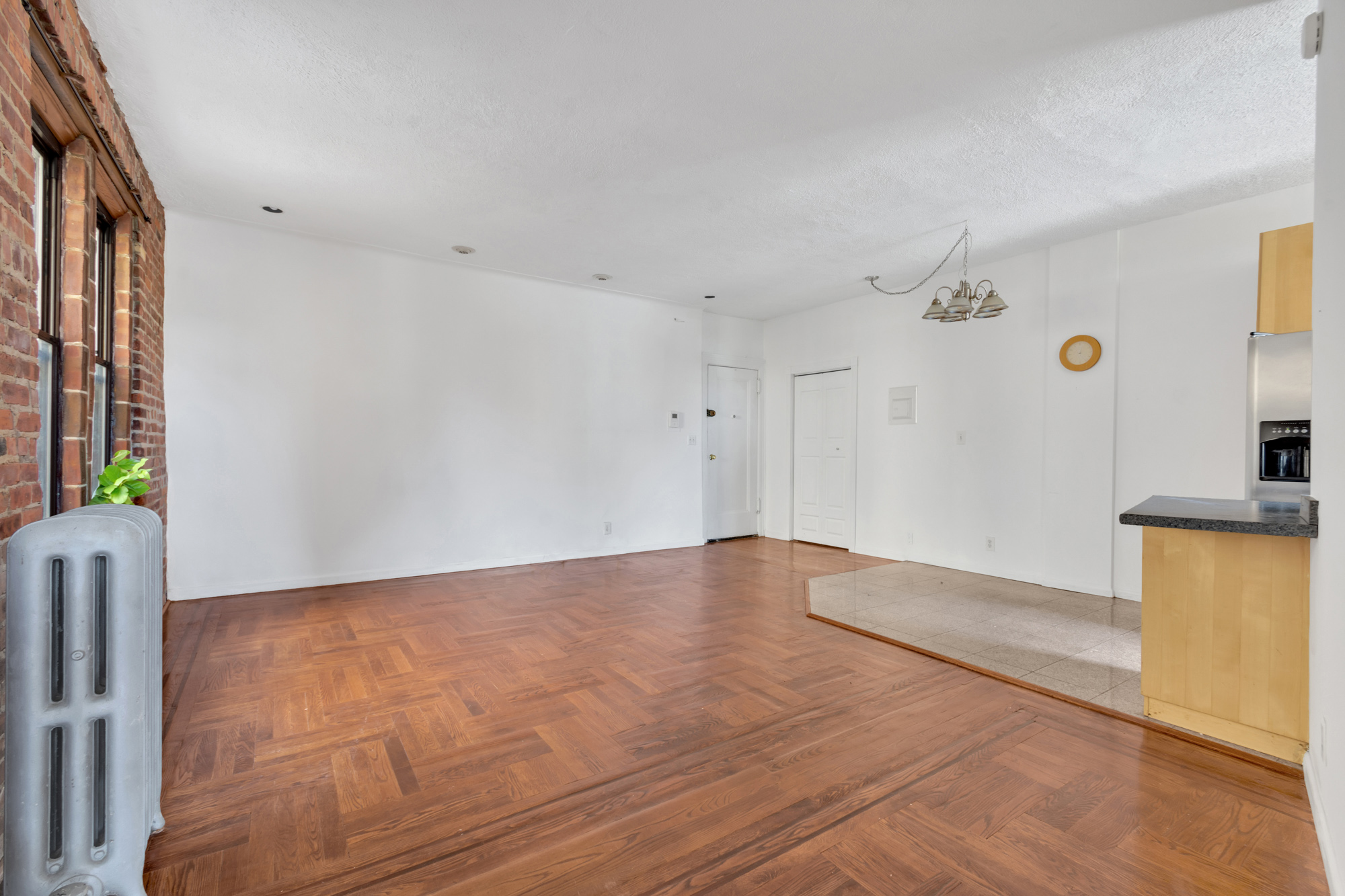 7609 4th Avenue, Unit B1 Brooklyn, NY 11209 - Photo 6 of 17 a view of an empty room with window and wooden floor
