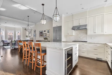 a kitchen with stainless steel appliances granite countertop a kitchen island a stove and a sink
