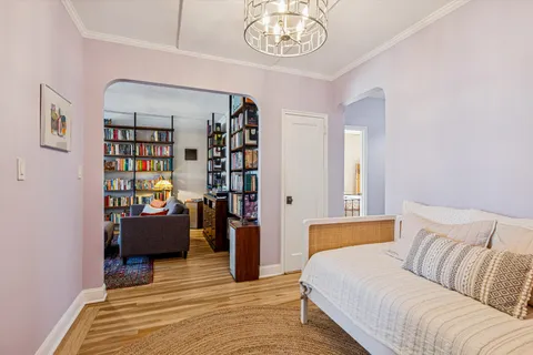 a bedroom with furniture and a book shelf