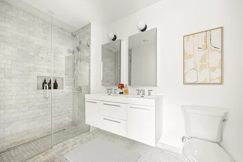 a bathroom with a bathtub sink mirror and vanity