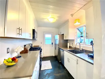 a kitchen with stainless steel appliances granite countertop a sink and cabinets