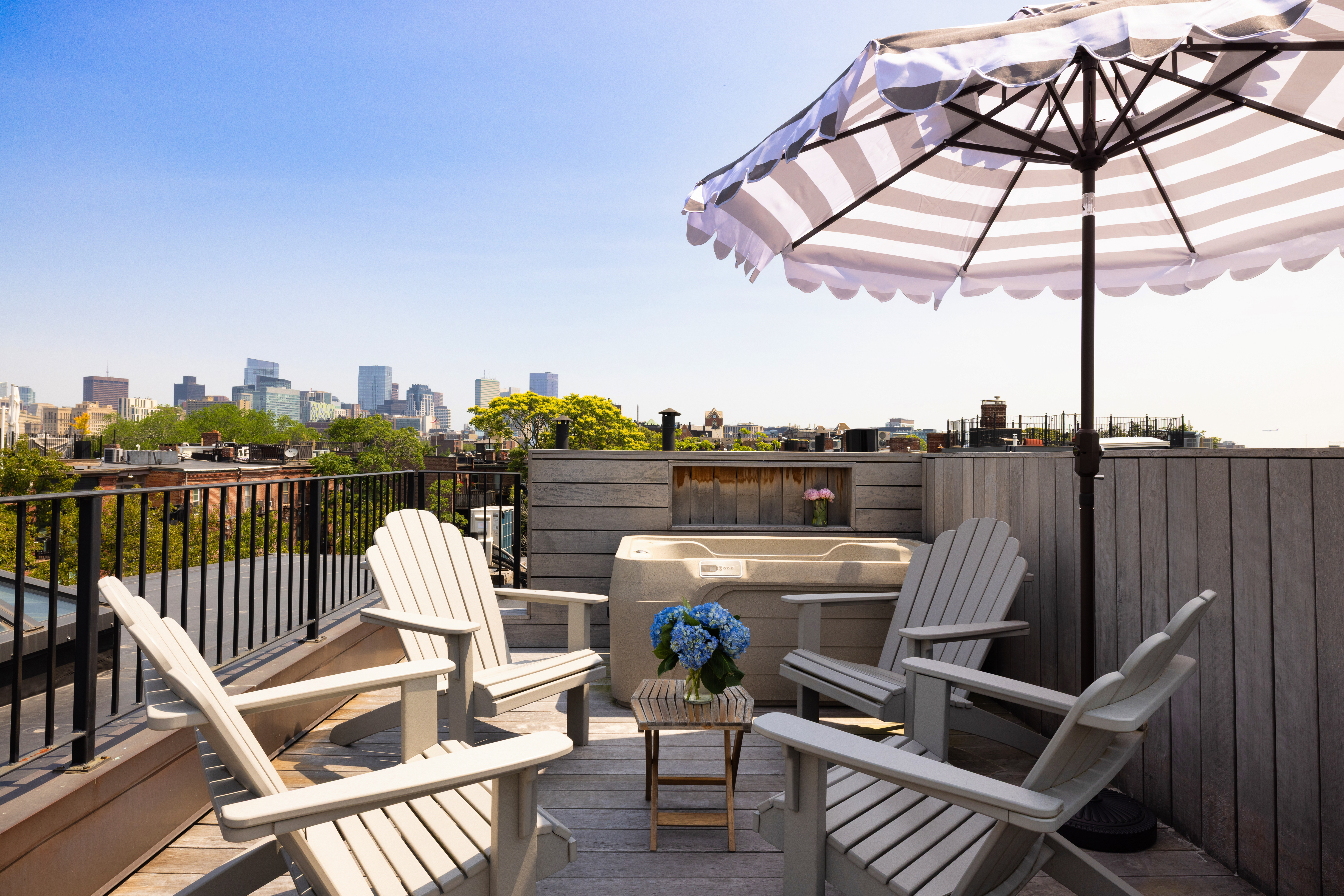South End Boston, MA 02118 - Photo 21 of 24 a view of a roof deck with couches under an umbrella